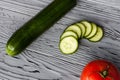 An appetizing composition of whole and sliced Ã¢â¬â¹Ã¢â¬â¹ripe cucumbers and tomato